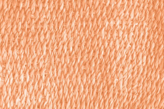 Foto wicker-stroh-hintergrund-trendfarbe des jahres 2024 peach fuzz