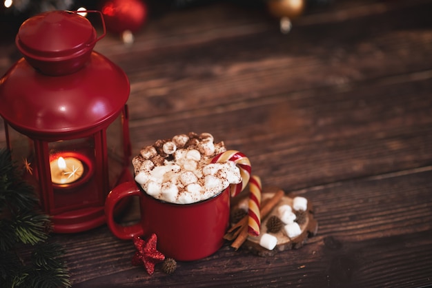 Winter Schlagsahne heißen Kaffee in einer roten Tasse mit sternförmigen Keksen und warmen Schal -