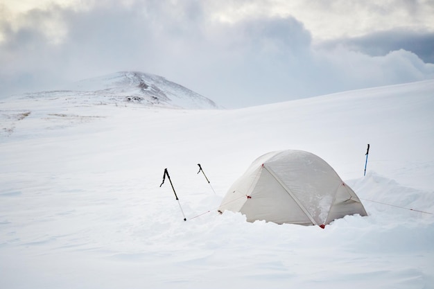 Wintercamping Weißes Touristenzelt, das auf Wintergebirge steht, das von Schnee bedeckt ist Wintertouristische Wanderwege in den Karpaten Borzhava, Ukraine