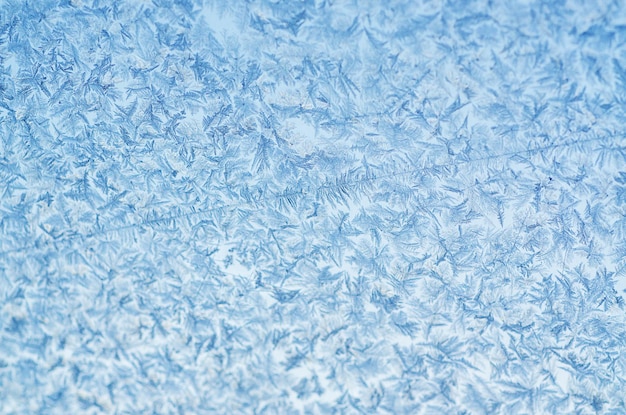 Winterschneeflockenmuster auf Glas, saisonaler Hintergrund des Feiertags