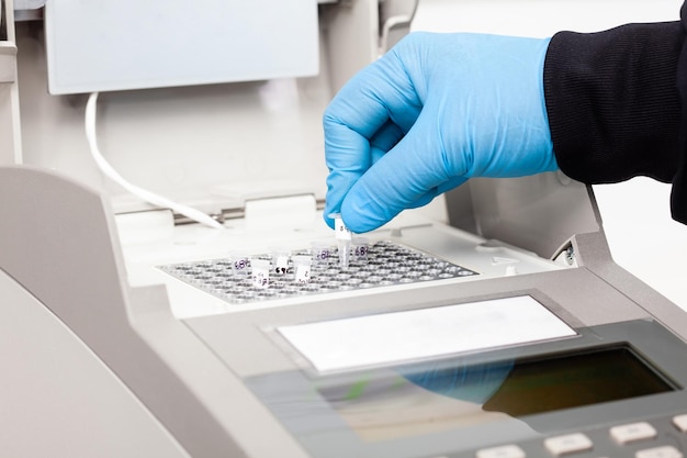 Wissenschaftler, der im Labor mit einer Thermalcycler-Polymerase-Kettenreaktion arbeitet