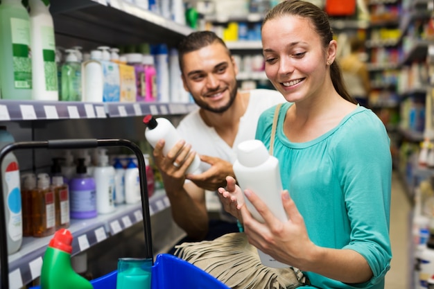 Woman select shampoo in store