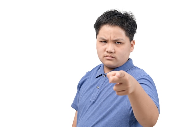 Wütender fettleibiger Junge zeigt mit dem Finger auf die Kamera isoliert auf weißem Hintergrund, Gesicht Emotion Konzept