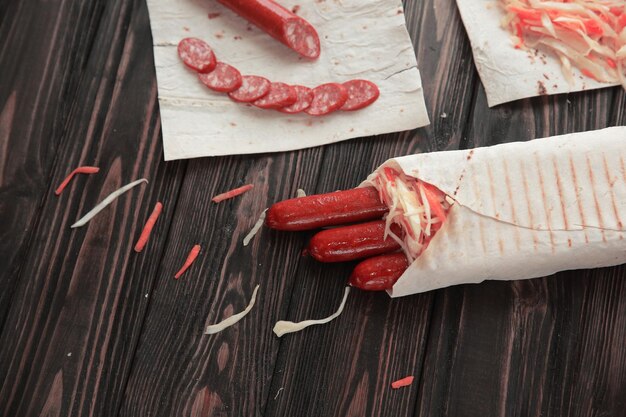 Wurst im Fladenbrot auf hölzernem Hintergrundfoto mit Kopierraum