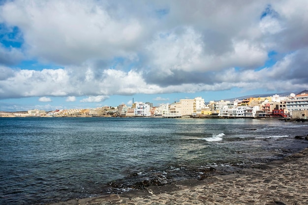 XALow Cumulus-Wolken bei Ebbe und ruhigem Meer in der Nähe des Ferienortes El Medano Teneriffa Kanarische Inseln Spanien