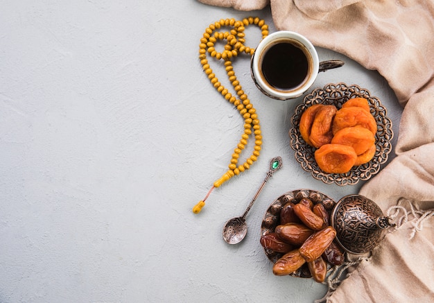 Foto xícara de café com frutas secas datas e damasco