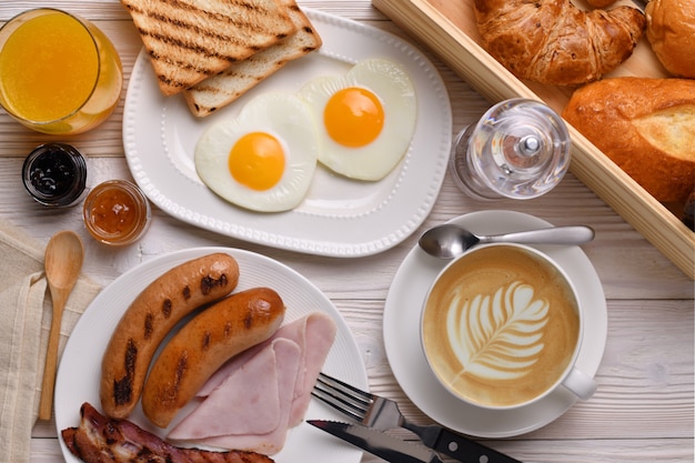 Xícara de café com leite com café da manhã na mesa de madeira