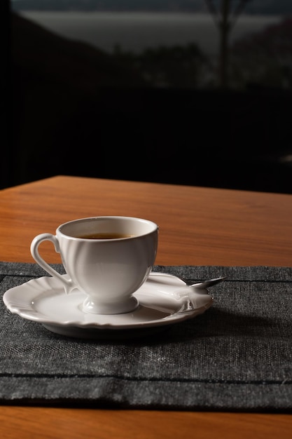 xícara de café em cima de uma mesa de madeira