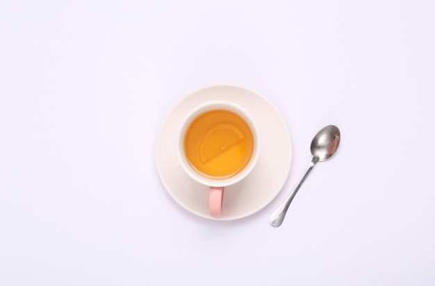 Xícara de chá aromático preto com limão no fundo branco