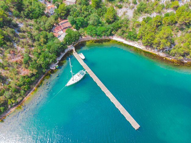 Yate en el muelle agua de la bahía azul