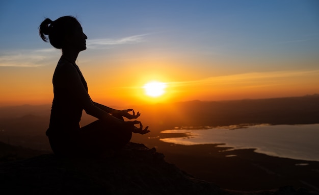 Yoga de silueta en la montaña