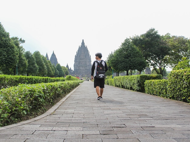 Yogyakarta julho de 2021 Jovem posando com o Templo Prambanan ao fundo