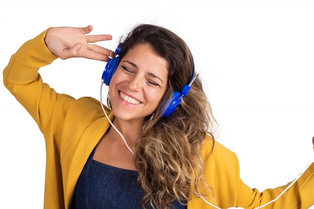 Yoman escuchando música con auriculares azules.