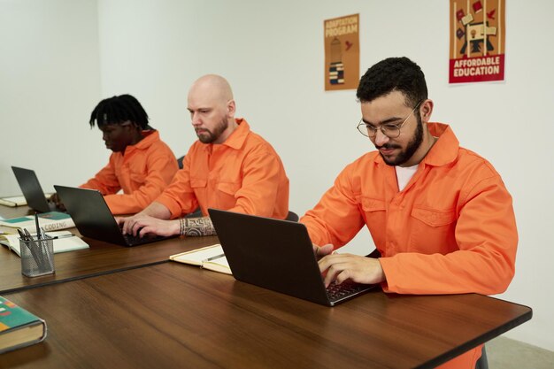 Young Adult Men of Diverse Ethnicities Using Laptops While Studying Together