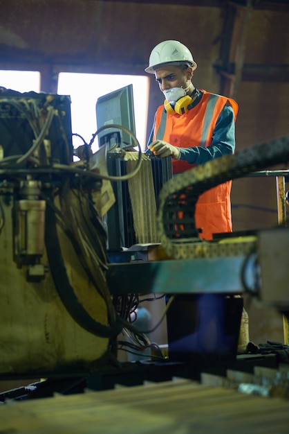 Young Worker Operating Machine