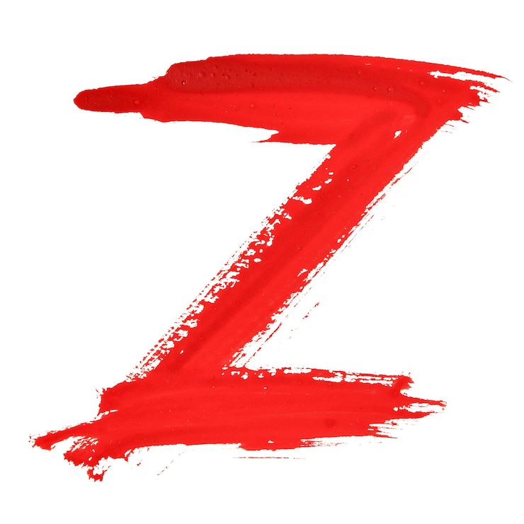 Foto z - letras manuscritas en rojo sobre fondo blanco.