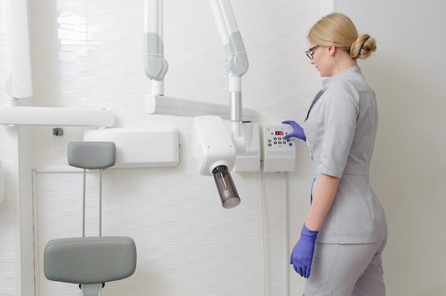 Zahnarzt in einem Röntgenraum arbeitet mit Geräten