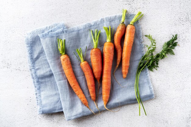 Zanahorias frescas jóvenes en una servilleta azul