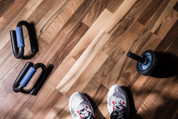 zapatillas de deporte y equipos deportivos se encuentran sobre fondo de madera