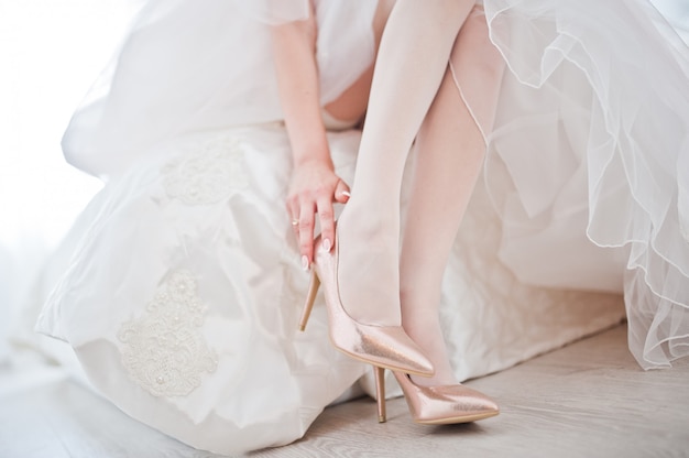 Zapatos blancos elegantes de la boda en la mañana de la novia.