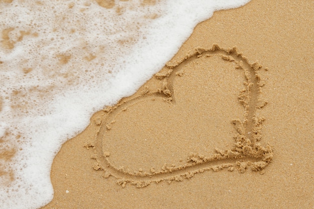 Zeichnung des Herzens auf dem Sand