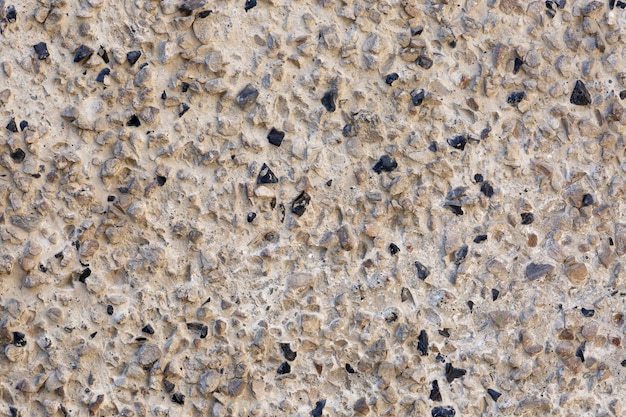Zementwand mit abstraktem Hintergrund der Steine, Obsidiansteine