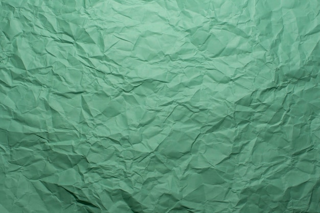 Zerknitterter grüner Papierbeschaffenheitshintergrund