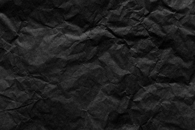 Zerknitterter Texturhintergrund aus schwarzem Papier für das Design in Ihrem Arbeitskonzept.