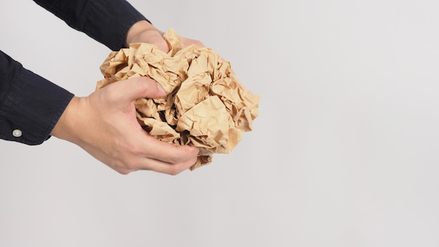 Zerknittertes braunes Papier. Es ist in der Hand des Mannes auf weißem Hintergrund zerknittert.