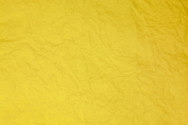 Zerknittertes Vintages gelbes Papier strukturierter veralteter Hintergrund.