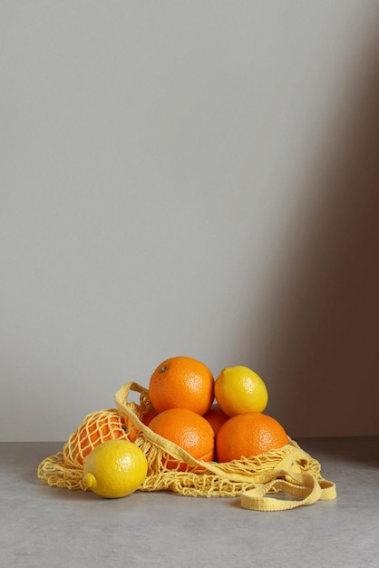 Zero Waste Packaging Orangen und Zitronen in einem Stringbeutel auf dem Tisch