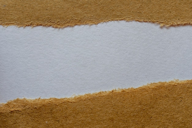 Zerrissenes braunes Papier mit weißem Hintergrund. Nachrichtenraum