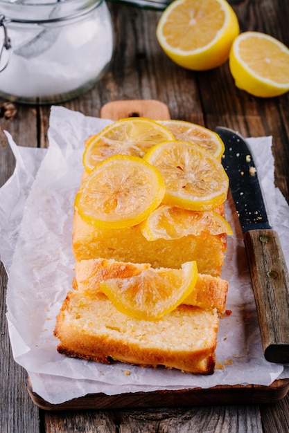 Zitronenkuchen mit kandierten Zitronenscheiben auf Holzhintergrund Selektiver Fokus