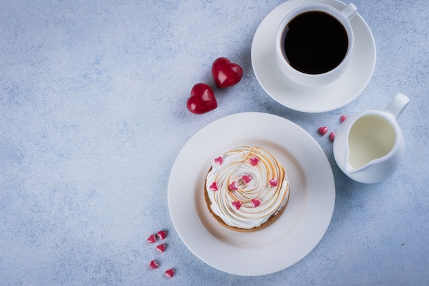 Zitronentorte mit Baiser und Tasse Kaffee, Milch mit Weihnachtsdekoration für Valentines d