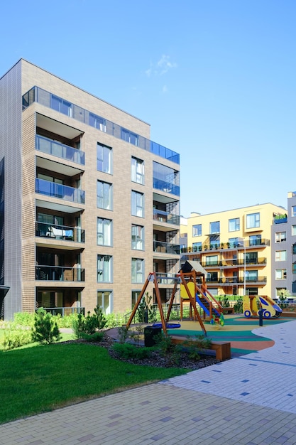 Zona de juegos para niños en el complejo del barrio del edificio residencial de apartamentos. E instalaciones al aire libre.