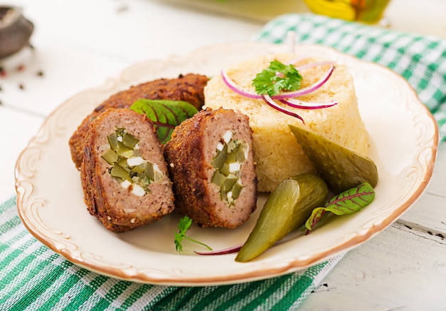 Zrazy Schnitzel mit Hackfleisch mit eingelegter Gurke und Eiern und Beilage von Bulgur