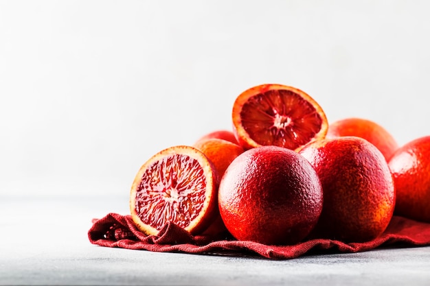 Zubereitung von Orangensaft Rote blutige Orangen auf grauem Küchentischhintergrund selektiver Fokusplatz für Text