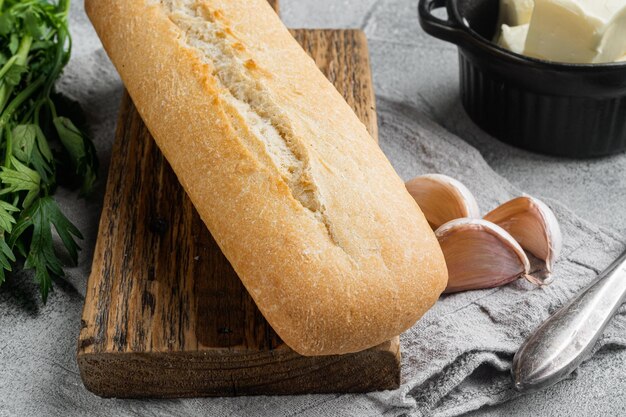 Zutaten für Baguette-Set mit Knoblauch und Gerbs-Brot, auf grauem Steintischhintergrund