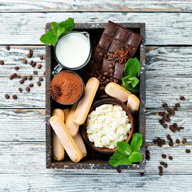 Zutaten für Nachtisch Tiramisu auf weißem Holzhintergrund