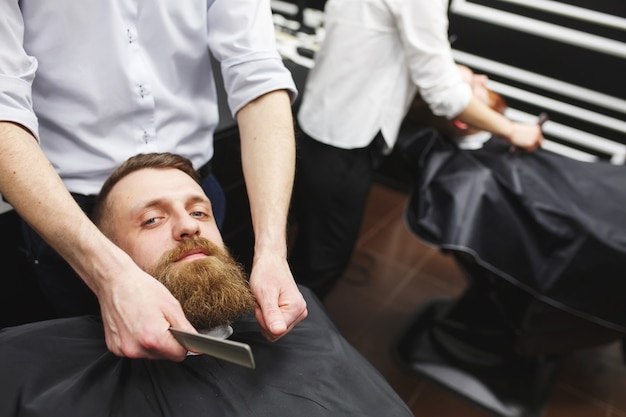 Zuversichtlich bemannt den Besuch von Friseuren im Friseursalon.