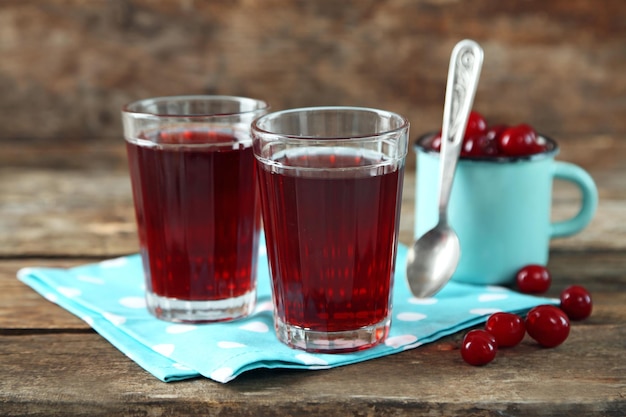 Zwei Gläser mit Kirschsaft auf dem Tisch auf hellem Hintergrund