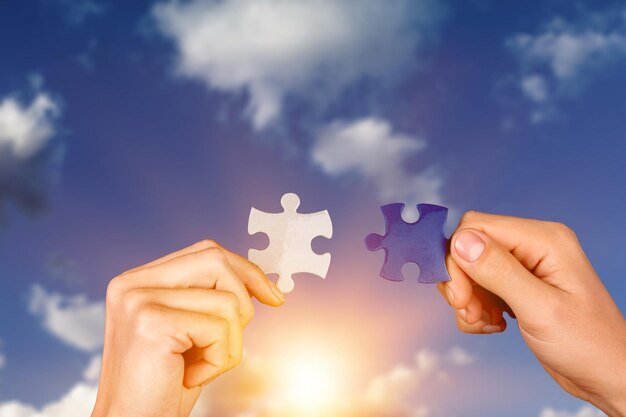 Zwei Hände, die versuchen, ein Paarpuzzle zu verbinden