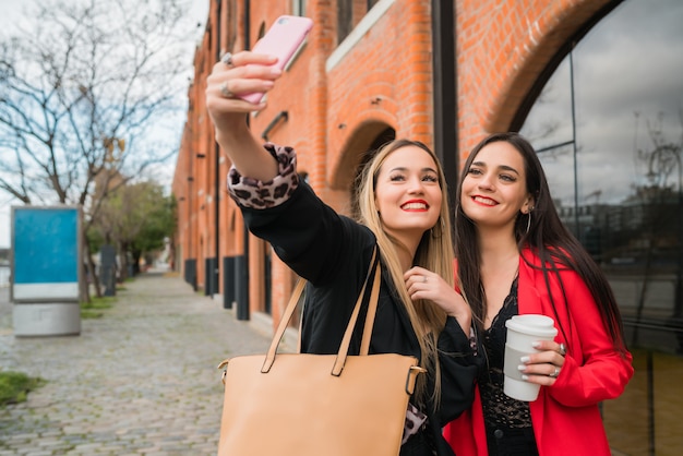 Zwei junge Freunde machen ein Selfie mit Handy.
