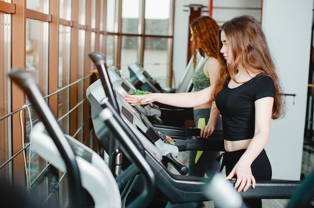 Zwei junge und athletische Mädchen treiben Sport im Fitnessstudio