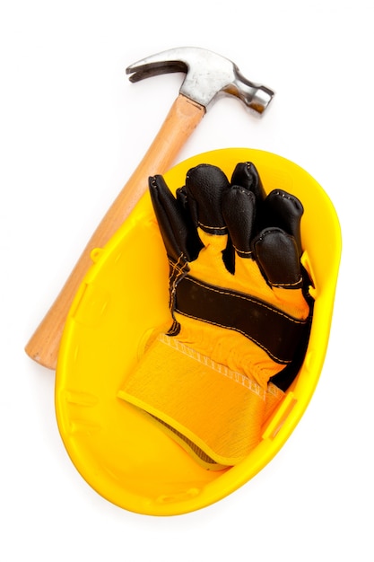 Foto zwei lederhandschuhe in einem sturzhelm mit einem hammer