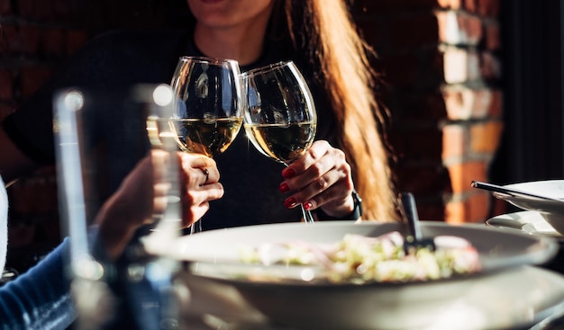Zwei Mädchen trinken Weißwein in einer Bar