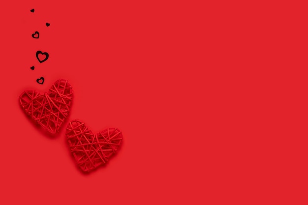 Zwei rote Herzen auf einem roten Hintergrund. Valentinstag Konzept. Kopie des Raumes. Von oben betrachten.