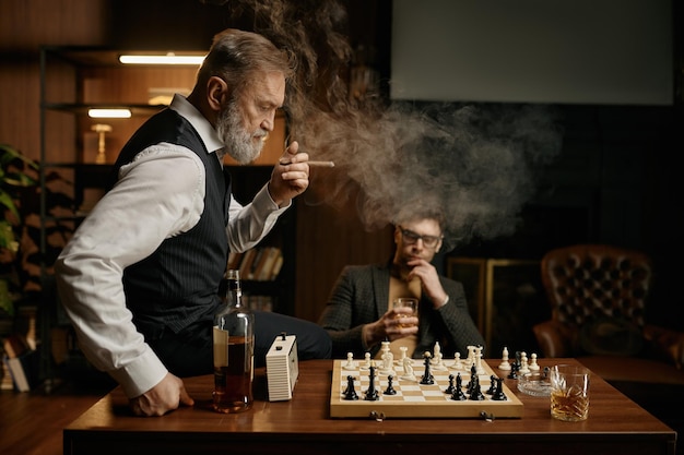 Zwei Schachspieler machen eine Pause, um Zigarre zu rauchen und die Spielstrategie zu planen