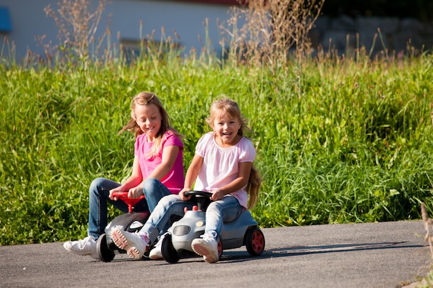 Zwei Schwestern mit Spielzeugautos