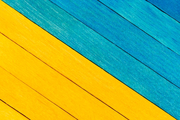 Zweifarbiger hölzerner strukturierter Hintergrund in den blauen und gelben Farben